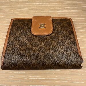 Well loved Celine Brown and Tan bi-fold wallet with kiss lock coin compartment.